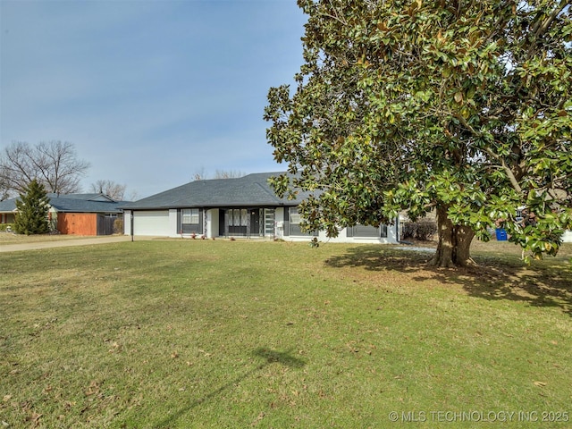 view of front of property with a front lawn and a garage