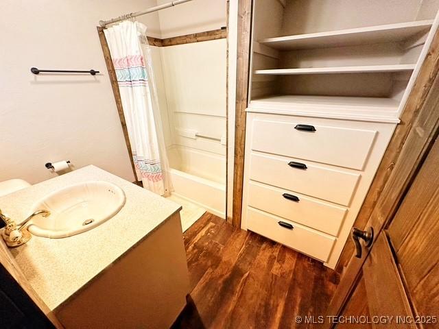 full bathroom with shower / bath combination with curtain, wood finished floors, and vanity