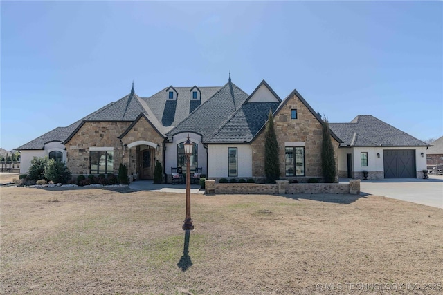 french provincial home featuring driveway, a shingled roof, a garage, and a front lawn