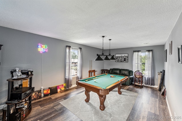 game room with a textured ceiling, dark wood-type flooring, and pool table