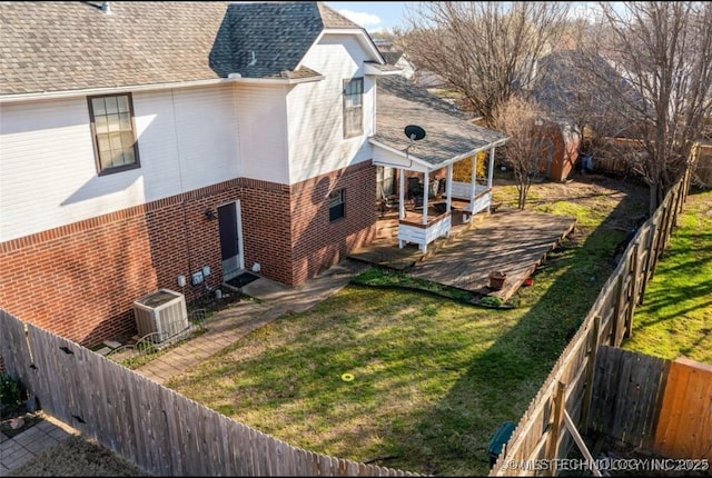 view of side of property with central AC unit and a lawn