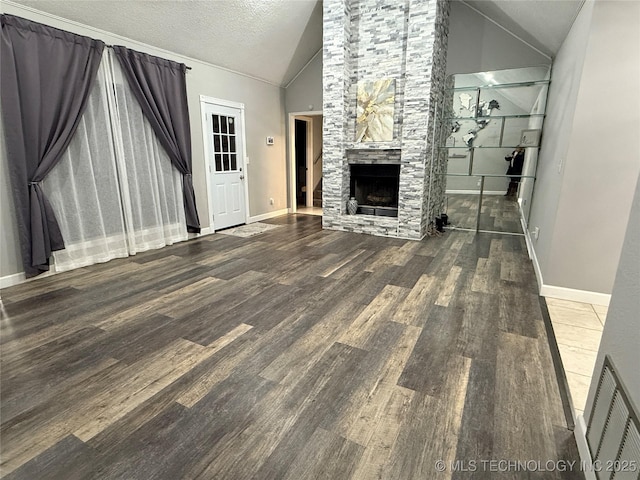 unfurnished living room with a fireplace, high vaulted ceiling, hardwood / wood-style floors, and a textured ceiling