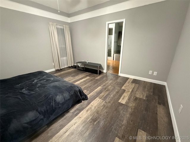 bedroom with dark hardwood / wood-style floors