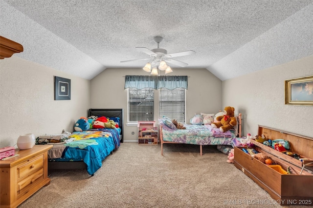 carpeted bedroom with a textured wall, vaulted ceiling, a textured ceiling, and ceiling fan