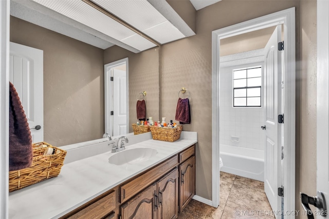 full bath with tile patterned flooring, toilet, bathtub / shower combination, vanity, and baseboards