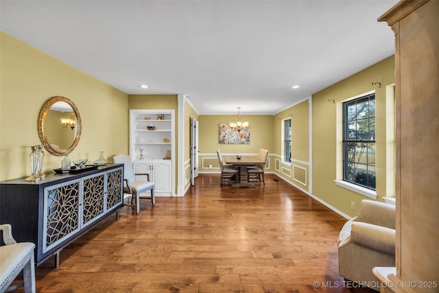 interior space with an inviting chandelier, baseboards, wood finished floors, and recessed lighting