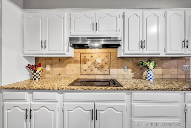 kitchen featuring stone countertops, range hood, white cabinetry, and black electric stovetop