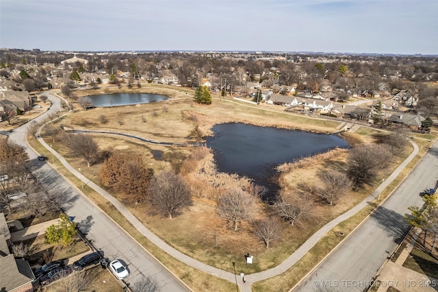 bird's eye view featuring a water view and a residential view