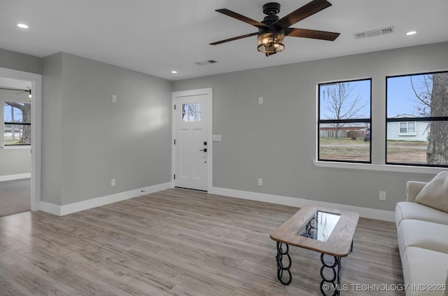 living room featuring light hardwood / wood-style floors and ceiling fan