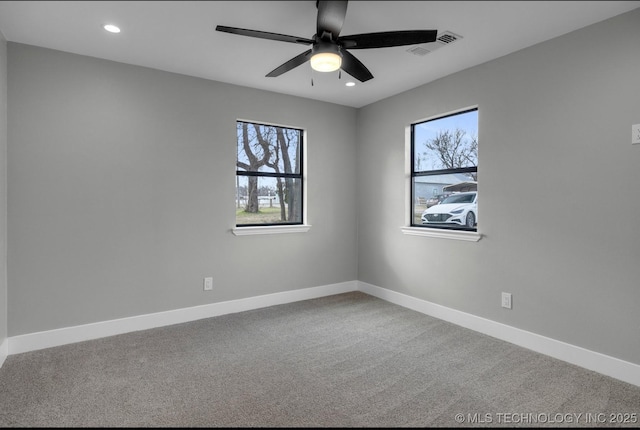 carpeted empty room featuring a healthy amount of sunlight and ceiling fan