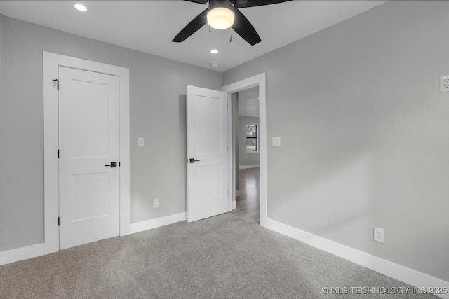 unfurnished bedroom with ceiling fan and light carpet