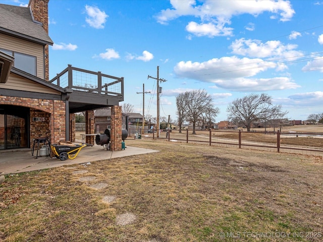 view of yard with a multi sided fireplace and a patio area