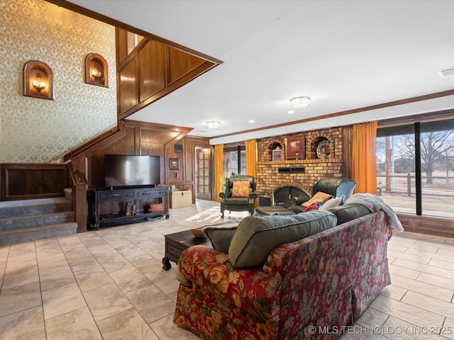 living room featuring ornamental molding and a brick fireplace