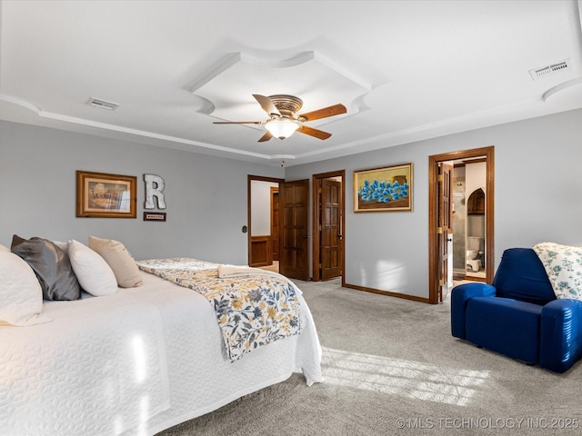 bedroom with ceiling fan, carpet flooring, and ensuite bath