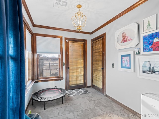 interior space with ornamental molding and a chandelier