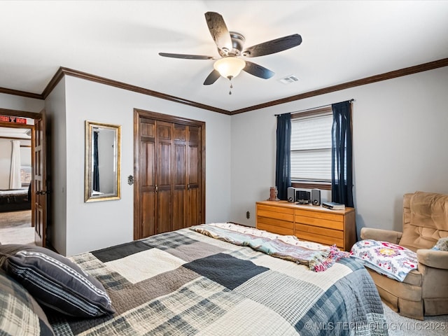 bedroom featuring ceiling fan, ornamental molding, and a closet