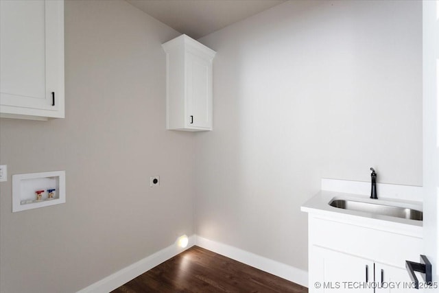 laundry room with dark wood-type flooring, hookup for a washing machine, electric dryer hookup, sink, and cabinets