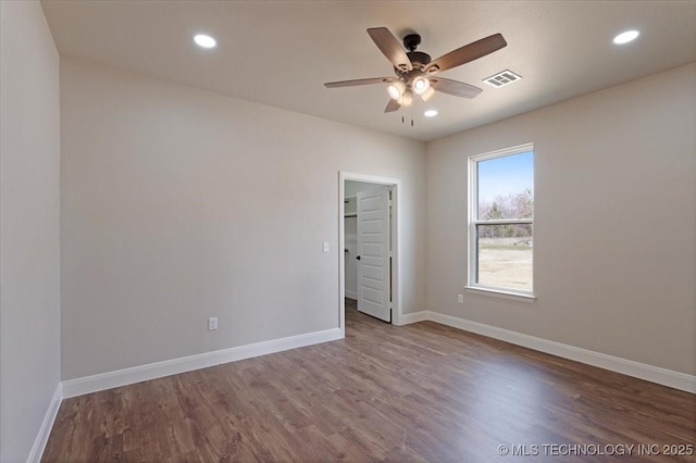 empty room featuring ceiling fan and wood-type flooring