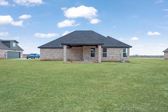 rear view of property with a yard