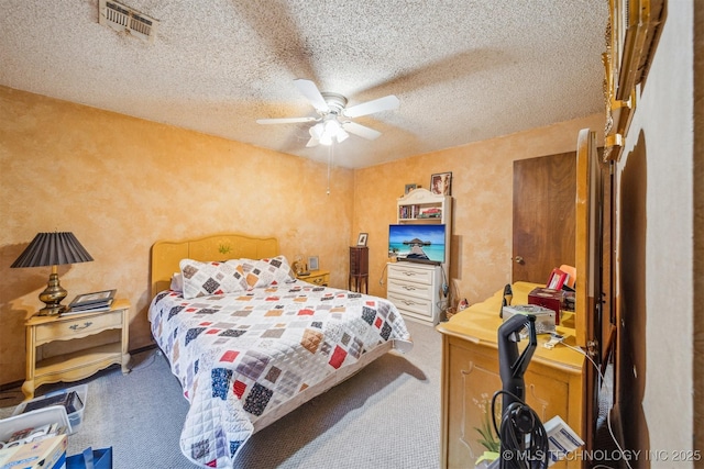 carpeted bedroom featuring ceiling fan and a textured ceiling