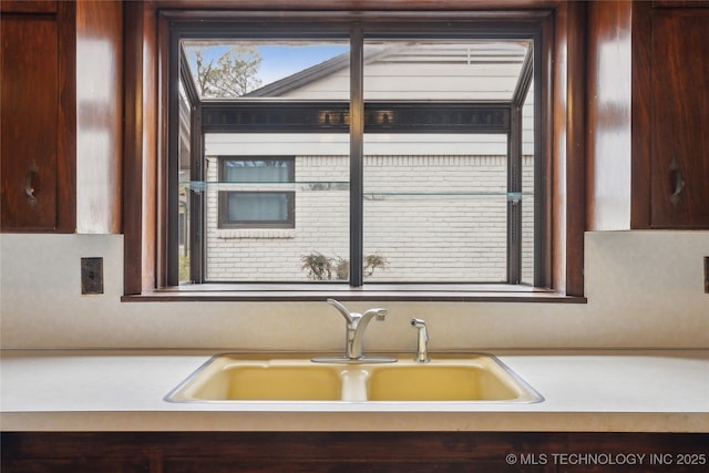 kitchen with dark brown cabinetry and sink