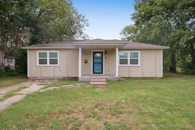 bungalow-style house with a front yard and a shingled roof