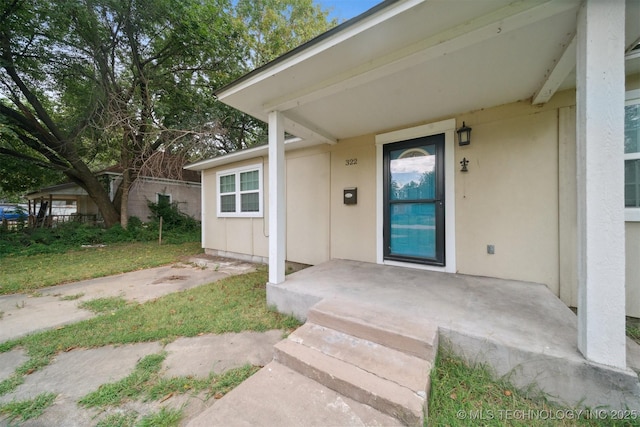 doorway to property with stucco siding