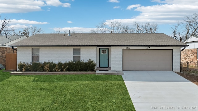 ranch-style house with a front lawn and a garage