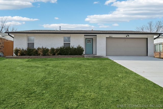 ranch-style house featuring a front yard and a garage