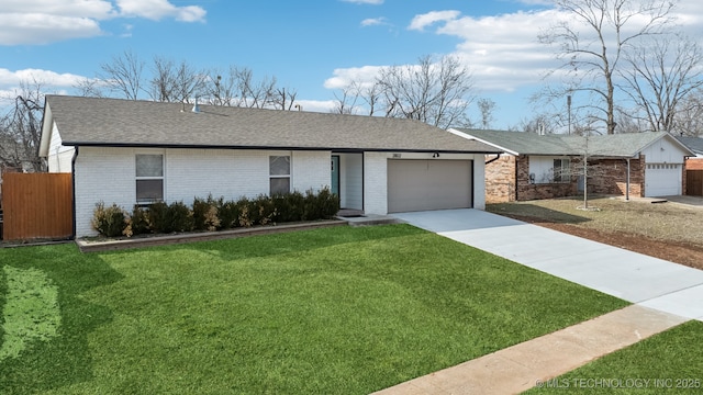 single story home with a front lawn and a garage