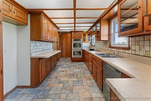 kitchen featuring sink, appliances with stainless steel finishes, and tasteful backsplash