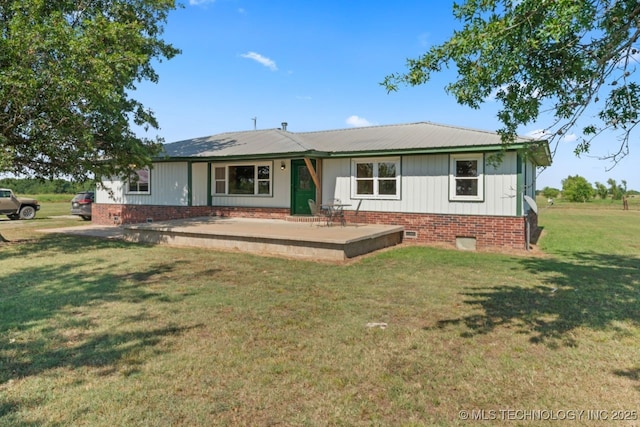 rear view of property with a lawn and board and batten siding