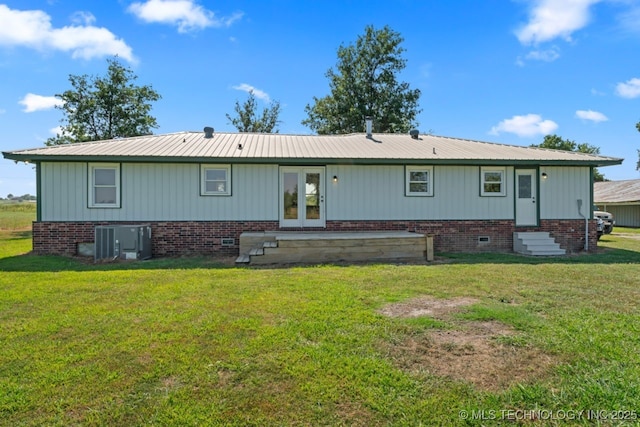 back of house featuring a lawn, french doors, and central air condition unit