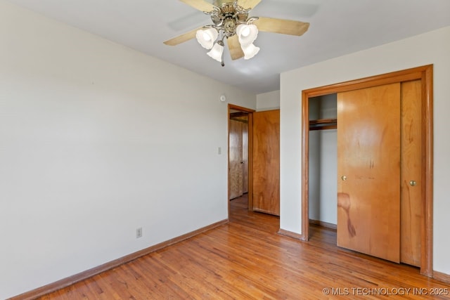 unfurnished bedroom featuring light wood-type flooring, a closet, and ceiling fan