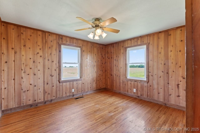 unfurnished room featuring hardwood / wood-style floors and ceiling fan