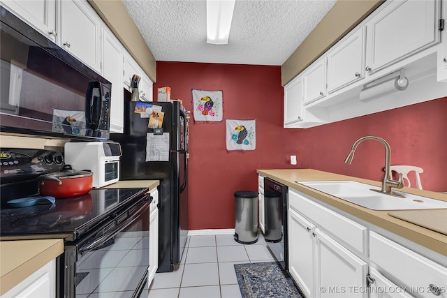 kitchen featuring light countertops, white cabinetry, a sink, and black appliances