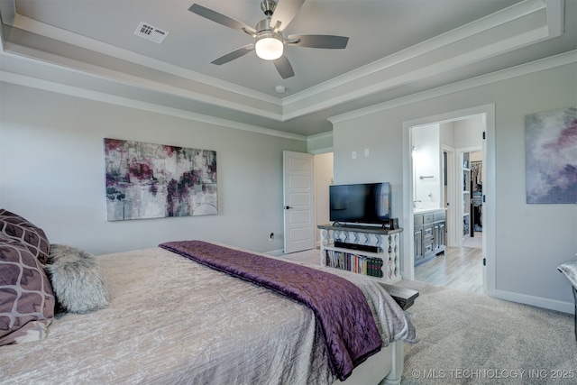 bedroom featuring baseboards, visible vents, a raised ceiling, light colored carpet, and crown molding