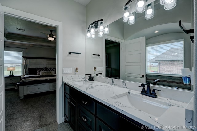 ensuite bathroom featuring a sink, double vanity, ensuite bath, and visible vents