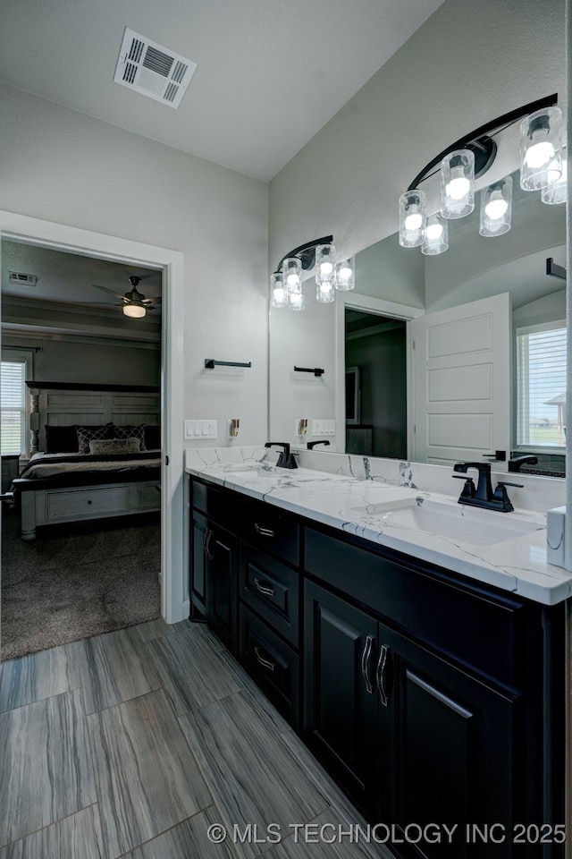 bathroom featuring double vanity, ensuite bath, visible vents, and a sink