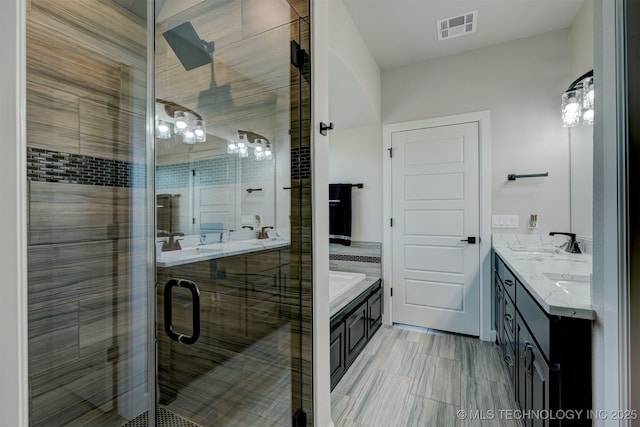 bathroom with double vanity, a stall shower, visible vents, a bath, and a sink