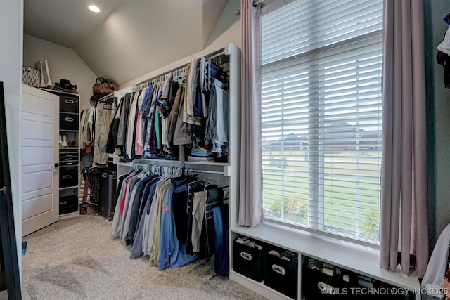 spacious closet with carpet floors and vaulted ceiling