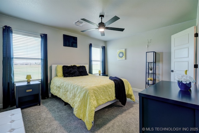 carpeted bedroom featuring visible vents and a ceiling fan