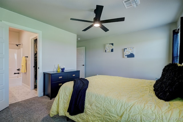 carpeted bedroom with a ceiling fan, visible vents, and ensuite bathroom