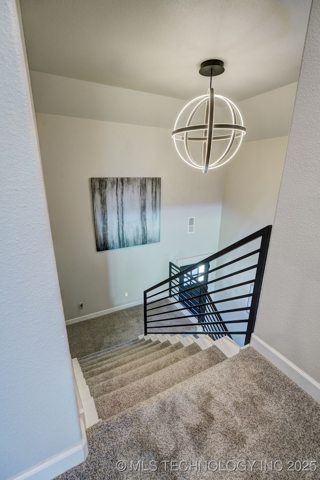 stairway featuring an inviting chandelier, carpet, visible vents, and baseboards