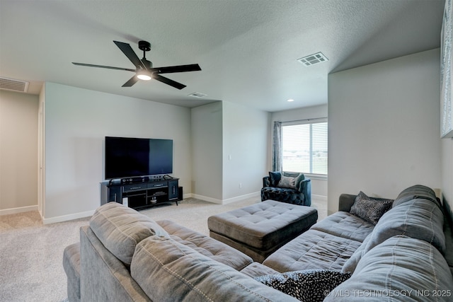 living area with light colored carpet, visible vents, and baseboards