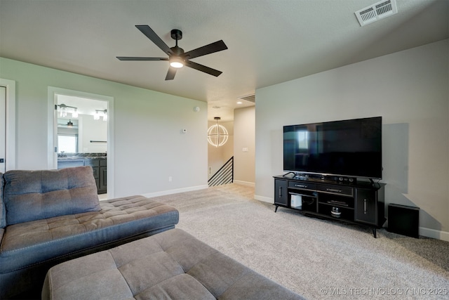 living area with a ceiling fan, carpet, visible vents, and baseboards