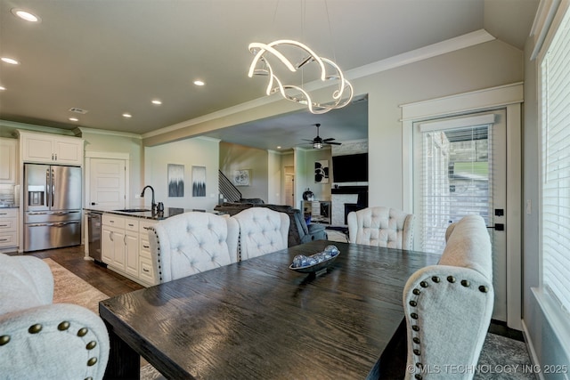 dining space featuring dark wood-style floors, ceiling fan with notable chandelier, ornamental molding, and recessed lighting