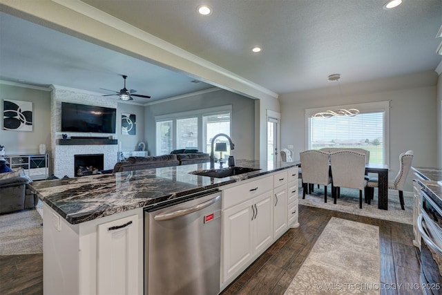 kitchen featuring a center island with sink, dark wood finished floors, dishwasher, white cabinetry, and a sink