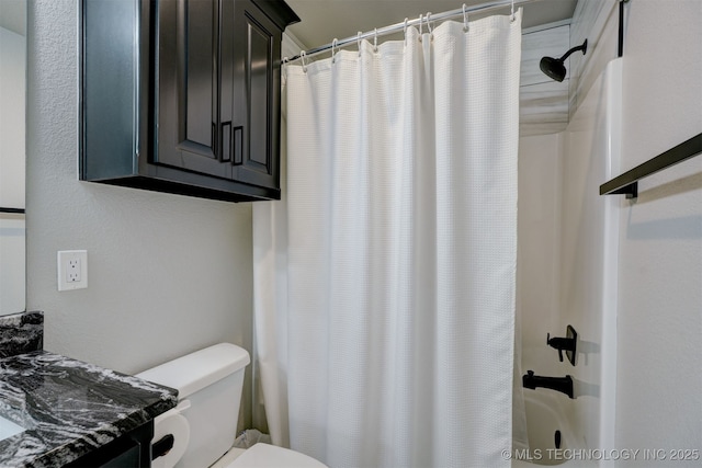 bathroom with curtained shower, vanity, and toilet