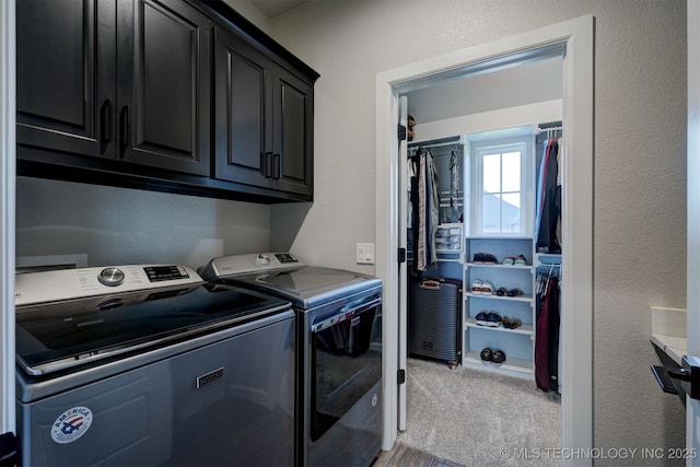 washroom featuring a textured wall, washing machine and clothes dryer, cabinet space, and light colored carpet